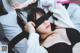 A woman laying on a bed with a cat mask on.