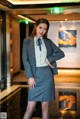 A woman in a business suit posing for a picture.