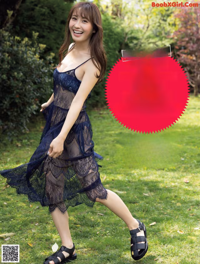 A woman in a black dress is walking in the grass.