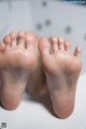 A close up of a baby's feet in a bathtub.