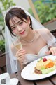 A woman in a wedding dress holding a glass of wine.